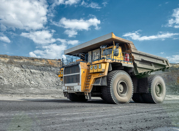 A mining truck is driving along a mountain road