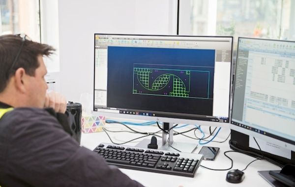Man looking at the 3d design in computer
